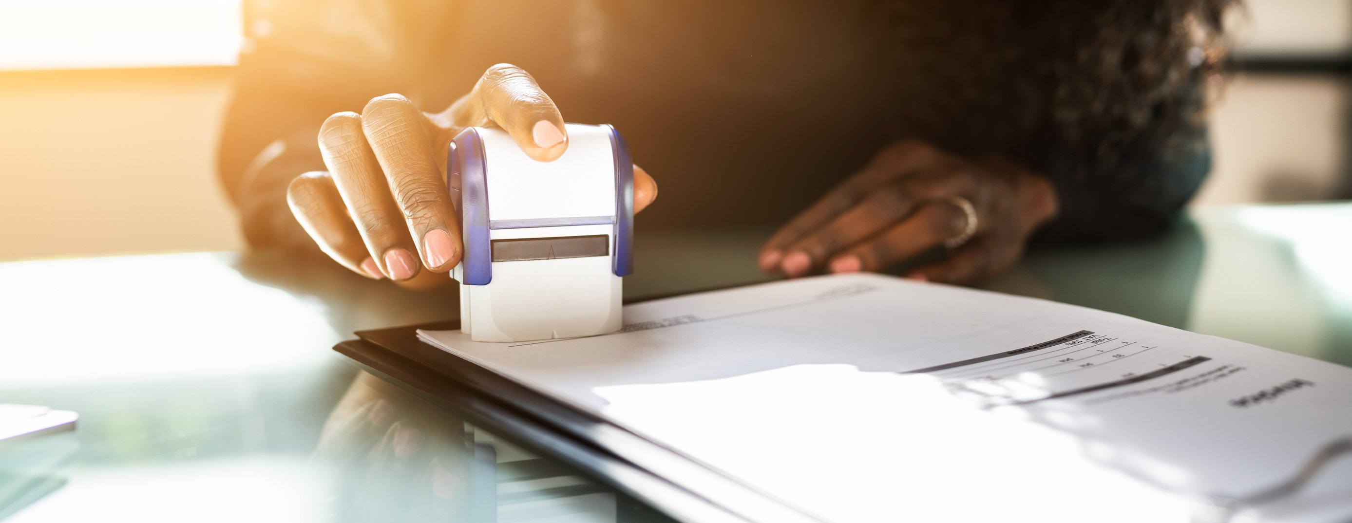 Businessperson Using a Notary Stamp on a Document